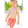 Boy Walking in Water Wearing Fruit Salad Swim Shorts